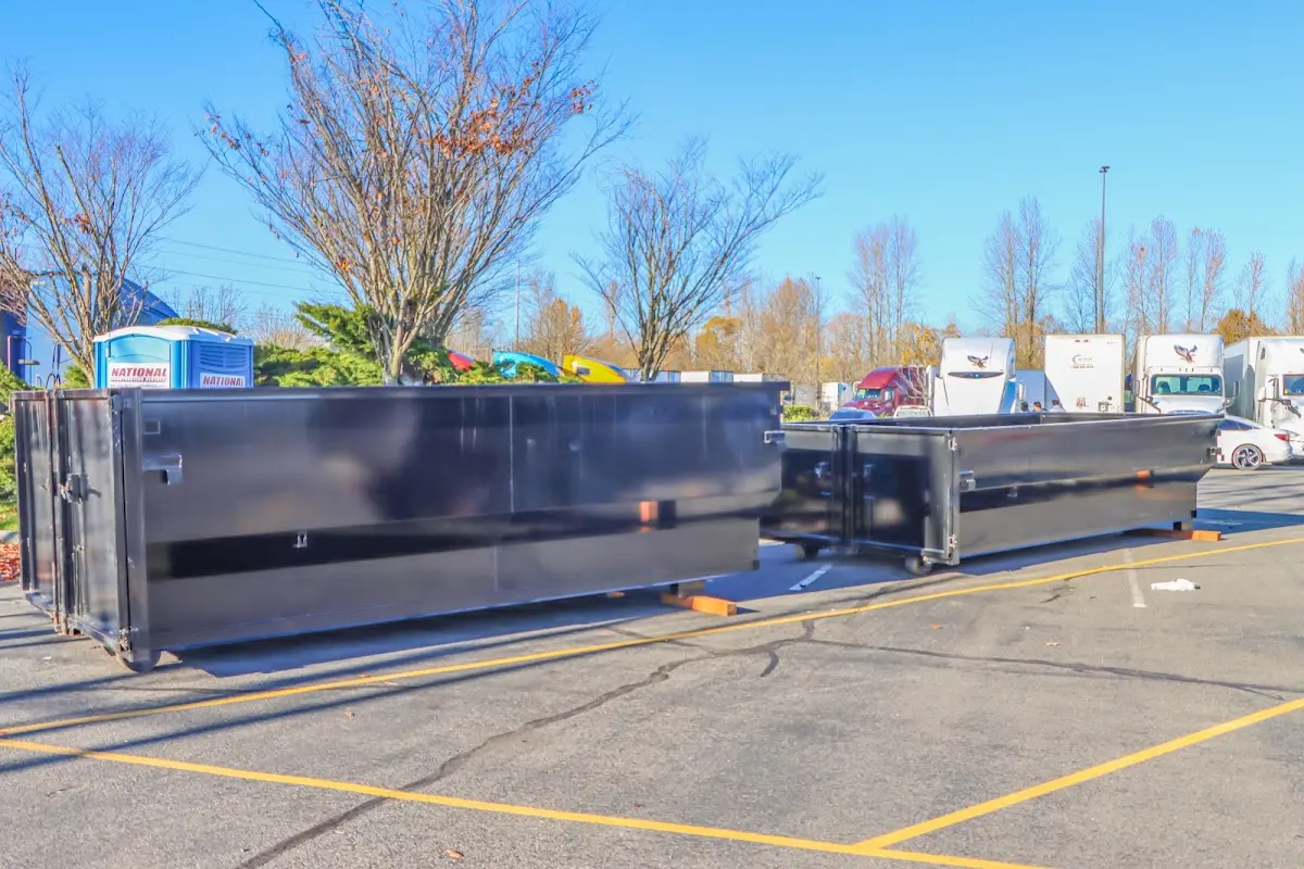 Professional dumpster rental service with roll-off container on residential driveway in Wailuku